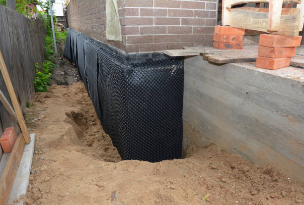 Happy homeowners after waterproofing job in Monroe